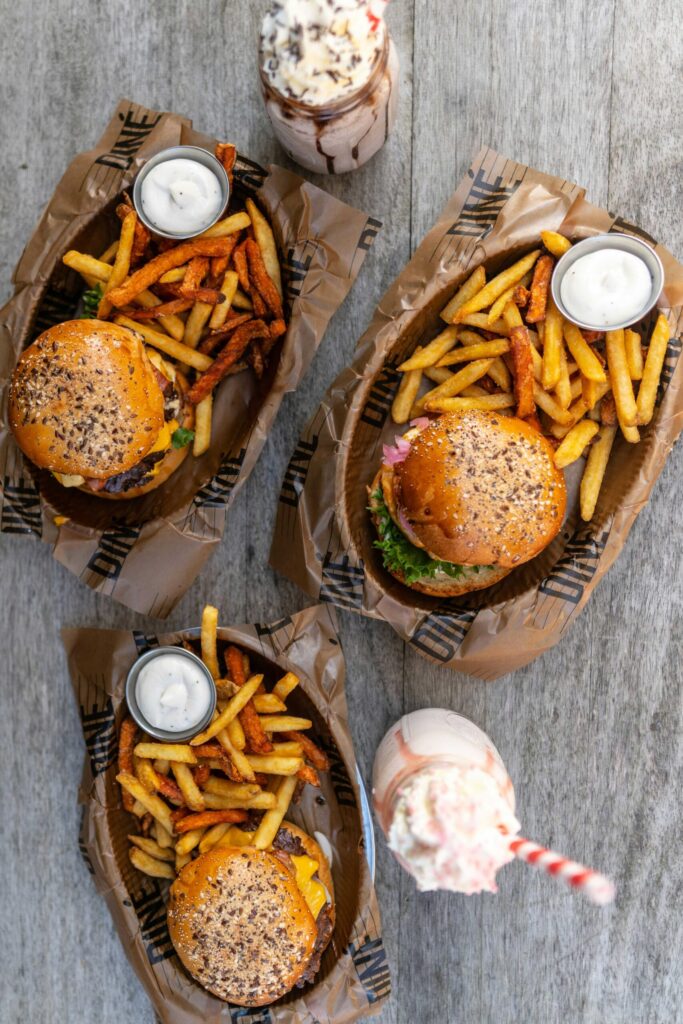 Two burgers and fries in takeaway trays, Burger King combo meal prices